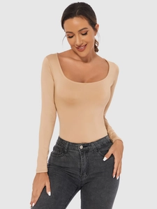 Close-up of beige long sleeve bodysuit with deep U-neckline and high elasticity texture