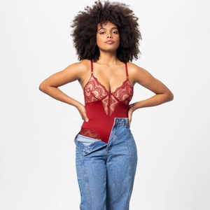 Detail of red floral lace stitching and adjustable thin straps on a deep V-neck bodysuit