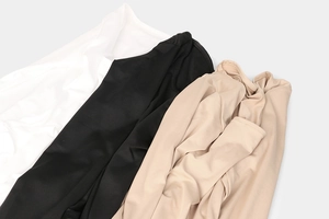 Close-up of soft elastic fabric textures in white, black and beige for bodysuit tops