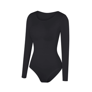 Detail of black long sleeve bodysuit showing ribbed knit fabric texture and round neckline