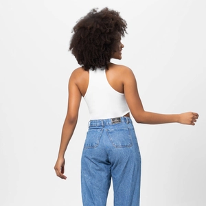 Close-up of ribbed halter neck top and denim jeans with leather waist patch detail