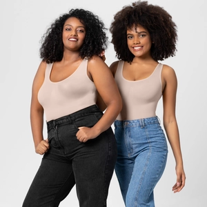 Detail of seamless slimming bodysuit in beige paired with high-waisted jeans