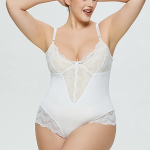 Close-up of white plus size bodysuit featuring delicate lace V-neckline and sheer details