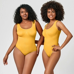 Detail view of yellow ribbed bodysuit on models showing seamless stretch and shaping effect