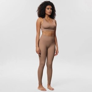 Detail view of coffee brown seamless ribbed yoga set featuring sports bra and high-waisted leggings