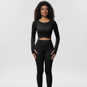 Close-up of black ribbed yoga set showing thumb holes and stretch knit fabric detail