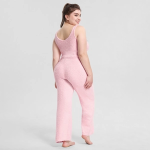 Detailed texture of pink plush loungewear set featuring soft coral fleece fabric texture
