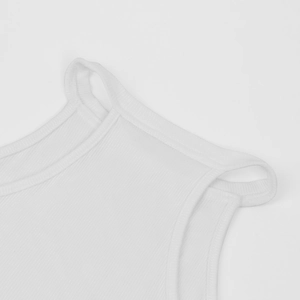 Close-up of white ribbed bodysuit featuring cut-out shoulder details and clean stitching