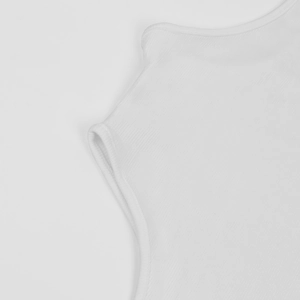 Detail of white ribbed knit fabric texture on a high-neck bodysuit for women