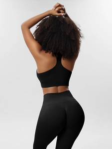 Back view of a black ribbed seamless yoga set showing racerback top and high waist leggings