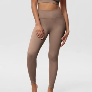 Detail of high waist seamless ribbed leggings and matching sports bra in brown