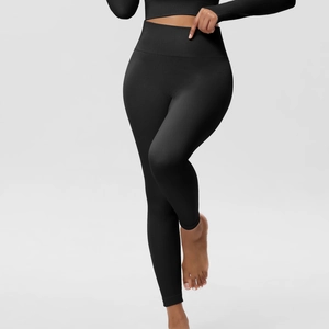 Close-up of black high-waisted seamless ribbed yoga leggings with body-sculpting texture