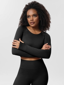 Detail view of black ribbed knit yoga set showing texture on long sleeve top and leggings