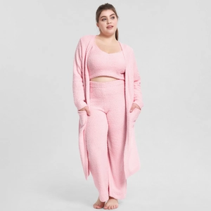 Detailed texture of light pink three-piece plush pajama set with soft coral fleece fabric