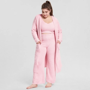 Detailed close-up of pink three-piece fleece pajama set with robe, top, and pants