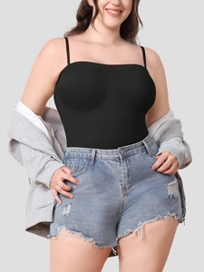 Detail of ribbed texture on black seamless bodysuit paired with casual denim shorts