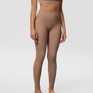 Close-up of seamless ribbed texture and high-waist fit on brown sports leggings