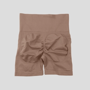 Macro detail of the high-waisted ribbed waistband and seamless taupe shaper fabric