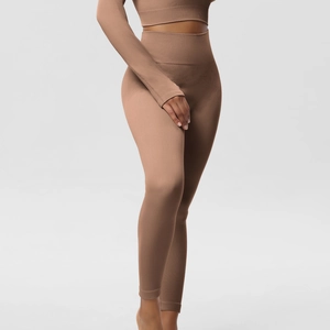 Detailed texture of high waist brown ribbed yoga set showing long sleeve top and leggings