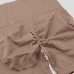 Close-up of seamless high-waist scrunch yoga leggings in Morandi brown-pink texture