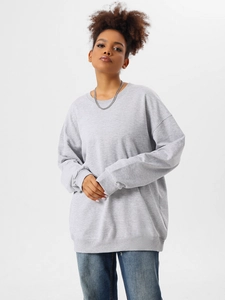 Detail of light grey oversized cotton sweatshirt showing ribbed cuffs and loose fit style