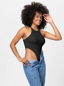 Women's black halter neck ribbed bodysuit with high cut leg paired with blue jeans