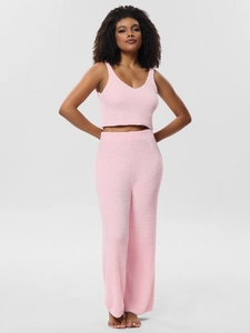 Detail view of pink plush two-piece sleepwear set showing soft texture and cozy fabric