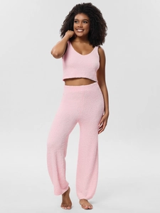 Detail of pink fleece three-piece pajama set showing soft plush texture and V-neck design