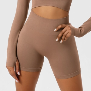 Detail showing the seamless ribbed high-waisted fitness shorts in brown elastic fabric