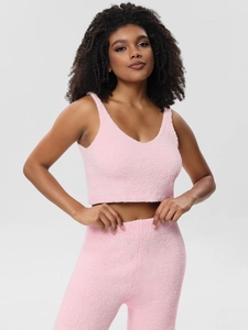 Detail view of pink three-piece pajamas set featuring plush fabric and V-neck camisole