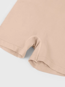 Detail of high-waist ribbed waistband and seamless stitching on beige shapewear
