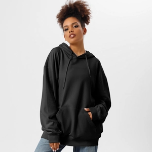 Detail of black oversized hoodie featuring a drawstring hood and spacious kangaroo pocket