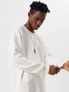 Detail view of white heavy cotton crewneck sweatshirt with relaxed drop shoulders