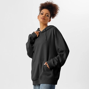 Detail of oversized black hoodie featuring heavy cotton fabric and ribbed cuffs on sleeve
