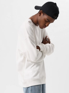 Clean detail shot of a white heavy cotton crewneck sweatshirt with ribbed cuffs and hem