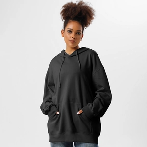 Detail of premium heavy cotton oversized black hoodie featuring kangaroo pocket and ribbed cuffs