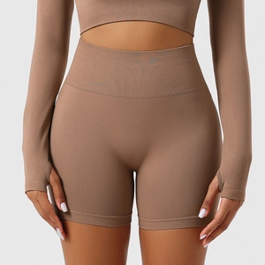 Detail of high waist seamless yoga shorts and long sleeve crop top with thumbholes