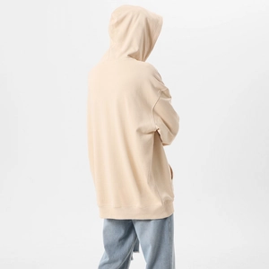 Back view of a loose oversized beige hoodie with dropped shoulders and ribbed hem detail