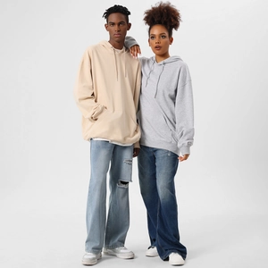 Couples wearing oversized drop shoulder hoodies with kangaroo pockets and drawstrings