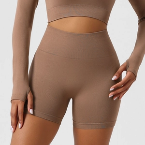 Close-up of seamless knitted texture on coffee high waist yoga shorts and crop top