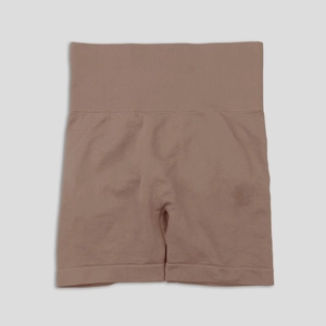Detail of high-waisted seamless ribbed waistband on tan sports shorts for tummy control