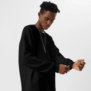 Detail of heavyweight cotton sweatshirt featuring ribbed cuffs and a relaxed drop shoulder