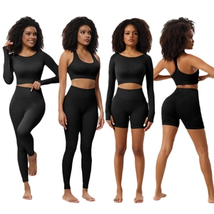 Women's black seamless ribbed yoga set including long sleeve crop top and high waist leggings