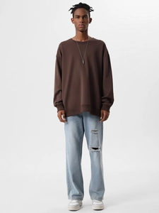Detailed view of heavy cotton brown crewneck sweatshirt with blue distressed denim jeans