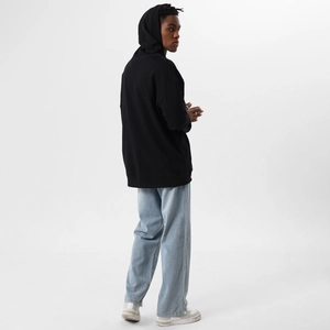 Rear view of an oversized black hoodie with loose-fit tailoring and a clean street style