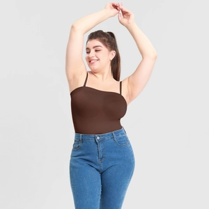 Detail of a brown seamless shaping bodysuit paired with high-waisted blue skinny jeans