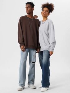 Detail of drop-shoulder crewneck sweatshirts in brown and light grey on models