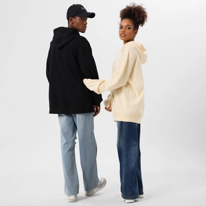 Detail of oversized black and cream hoodies showing thick cotton fabric and kangaroo pockets