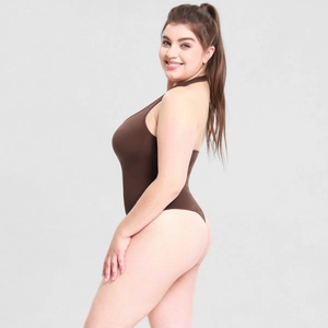 Detail of chocolate brown ribbed halter neck bodysuit with backless design on model