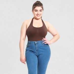Detail of a brown halter-neck bodysuit paired with high-waisted blue slim-fit jeans